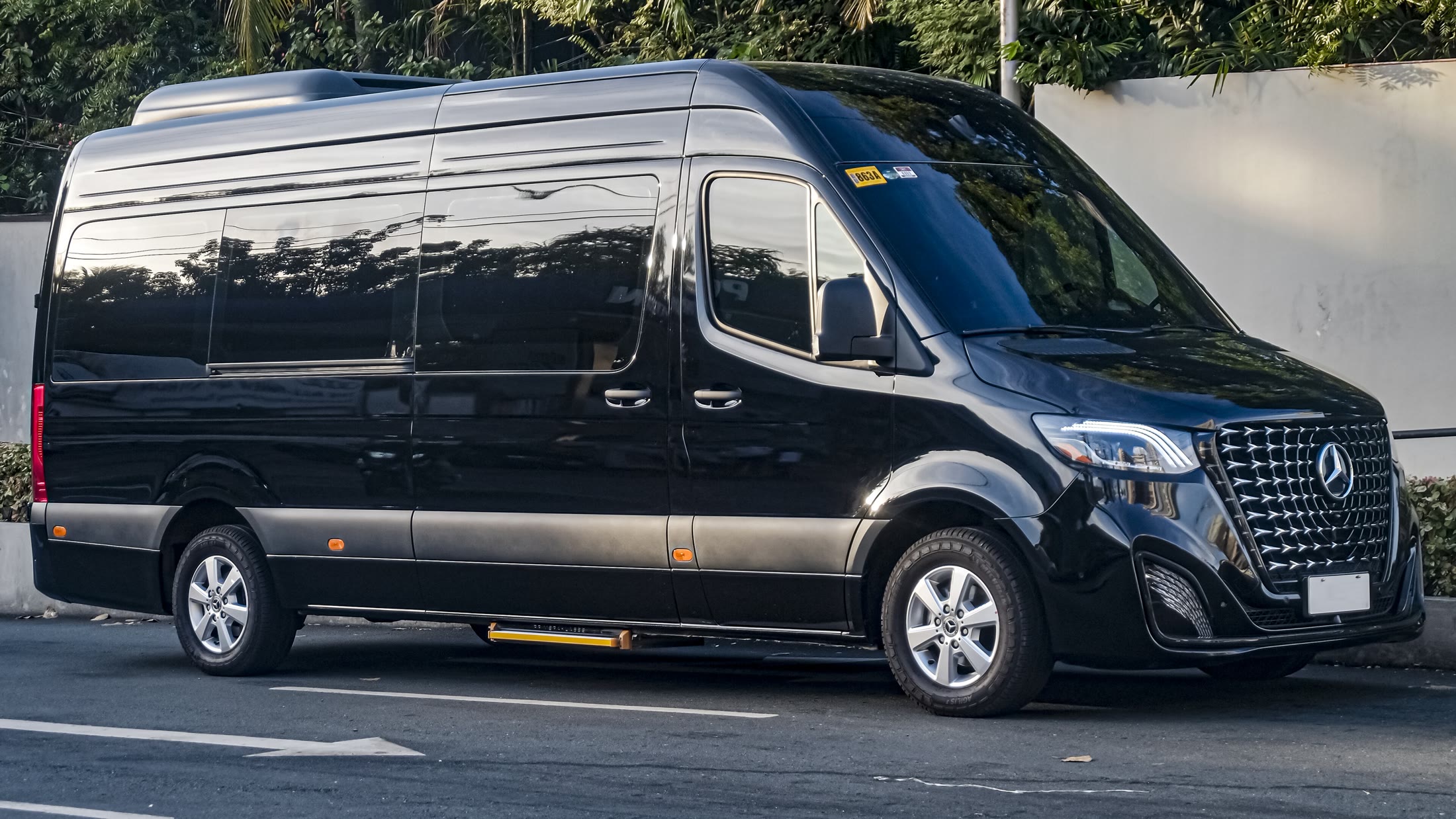 Black Mercedes-Benz Sprinter executive van at dusk